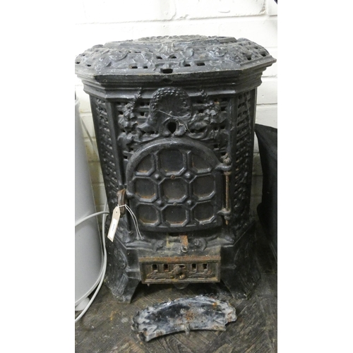 709 - An old ornate cast iron wood burning stove