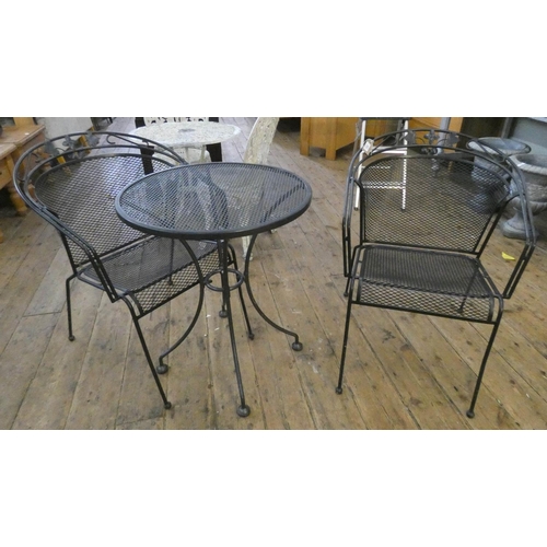 716 - A black metal circular garden table with two matching chairs