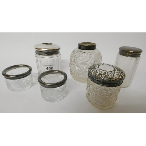 498 - A collection of silver topped dressing table jars, hair pin tidy etc