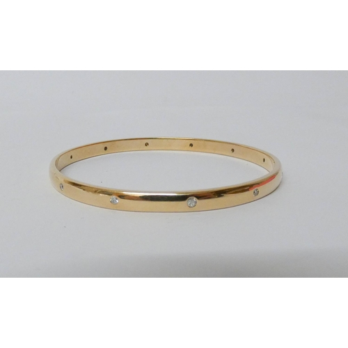 418 - A 9ct yellow gold bangle, set with 12 brilliant cut diamonds, hallmarked, gross weight 24.8g