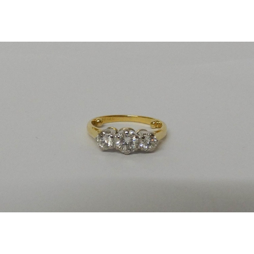 420 - A three stone diamond ring, on 18ct gold band, hallmarked, ring size G/H. Weight 3.1 grams