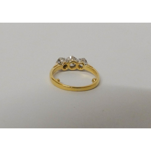 420 - A three stone diamond ring, on 18ct gold band, hallmarked, ring size G/H. Weight 3.1 grams