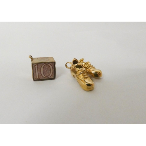 549 - A 9ct yellow gold charm pendant modelled as a pair of tap or Irish jig shoes and a £10 note charm. G... 