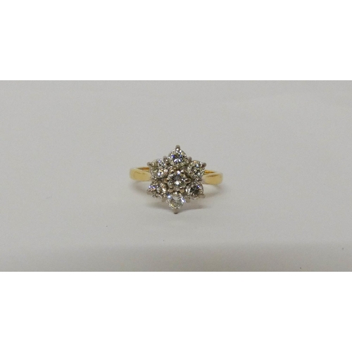 552 - A diamond daisy cluster ring, with seven brilliant cut diamonds on hallmarked 18ct yellow gold band.... 