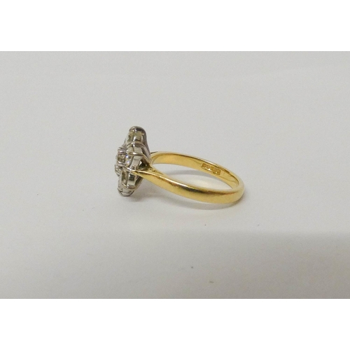 552 - A diamond daisy cluster ring, with seven brilliant cut diamonds on hallmarked 18ct yellow gold band.... 