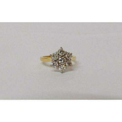 552 - A diamond daisy cluster ring, with seven brilliant cut diamonds on hallmarked 18ct yellow gold band.... 