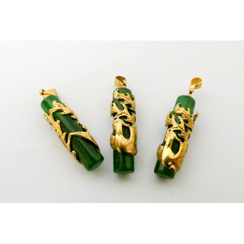 557 - Three matching jadeite and yellow metal bird appliqué pendants