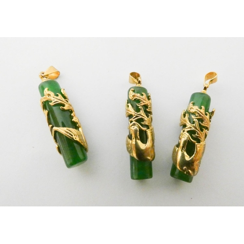 557 - Three matching jadeite and yellow metal bird appliqué pendants