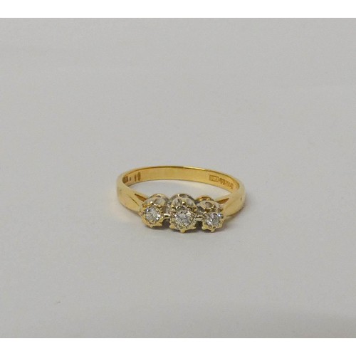 553 - A three stone diamond ring, on 18ct yellow gold hallmarked band, ring size N, weight 3 grams