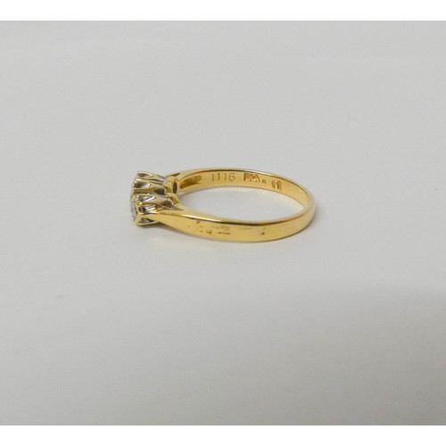 553 - A three stone diamond ring, on 18ct yellow gold hallmarked band, ring size N, weight 3 grams