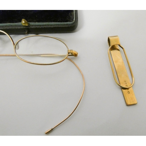 412 - A pair of gold framed vintage spectacles and a 9ct gold tie clip. Tie clip weighs 6.1 g