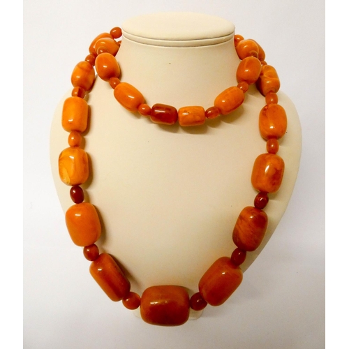 413 - Long Art Deco graduated row of butterscotch amber beads, gross weight 197 g
