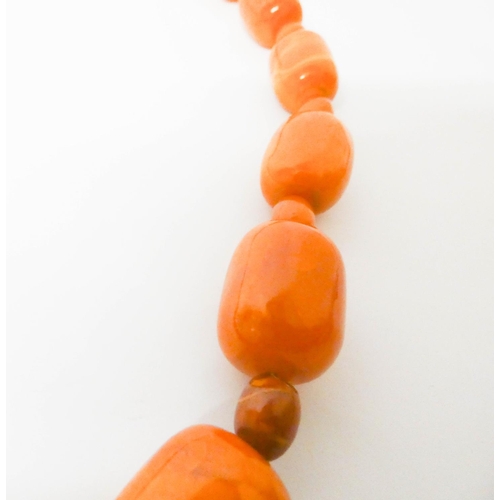 413 - Long Art Deco graduated row of butterscotch amber beads, gross weight 197 g