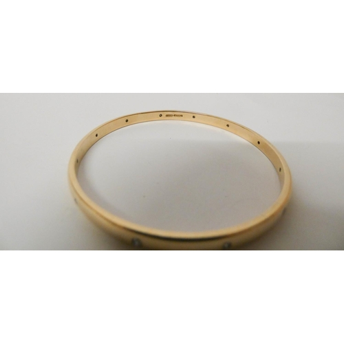 418 - A 9ct yellow gold bangle, set with 12 brilliant cut diamonds, hallmarked, gross weight 24.8g