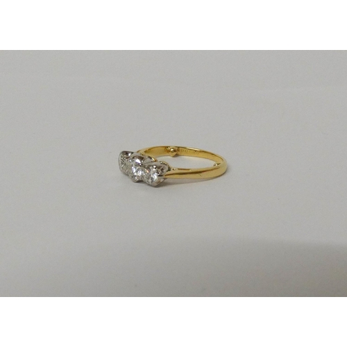 420 - A three stone diamond ring, on 18ct gold band, hallmarked, ring size G/H. Weight 3.1 grams