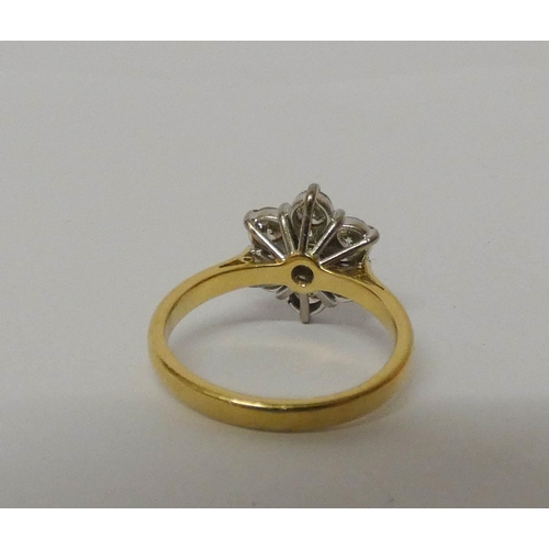 552 - A diamond daisy cluster ring, with seven brilliant cut diamonds on hallmarked 18ct yellow gold band.... 