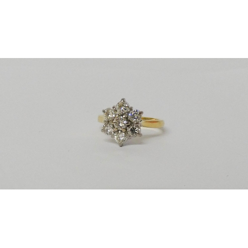 552 - A diamond daisy cluster ring, with seven brilliant cut diamonds on hallmarked 18ct yellow gold band.... 