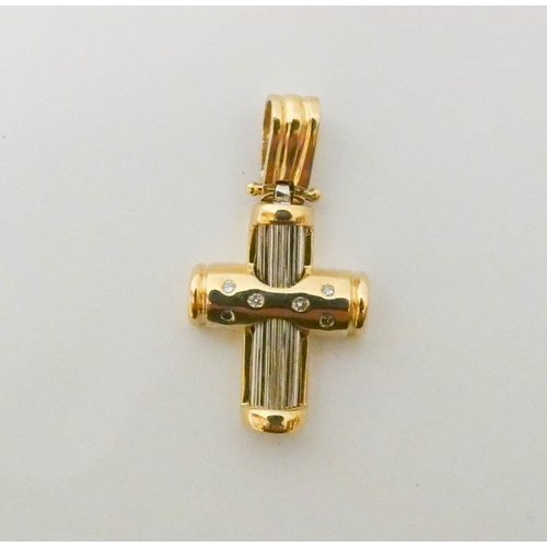 554 - A modern 18ct yellow and white gold diamond set cross pendant. Weight 4.4g