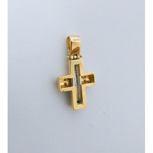 554 - A modern 18ct yellow and white gold diamond set cross pendant. Weight 4.4g