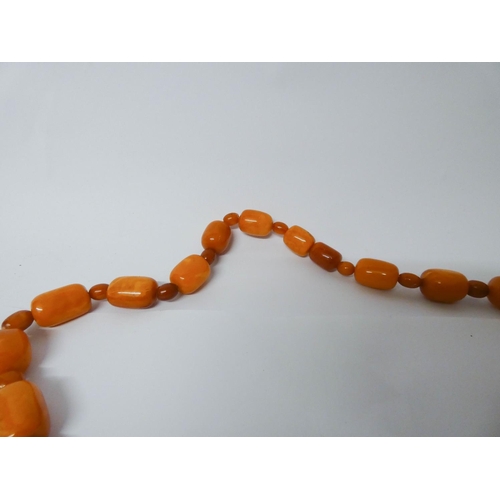 413 - Long Art Deco graduated row of butterscotch amber beads, gross weight 197 g