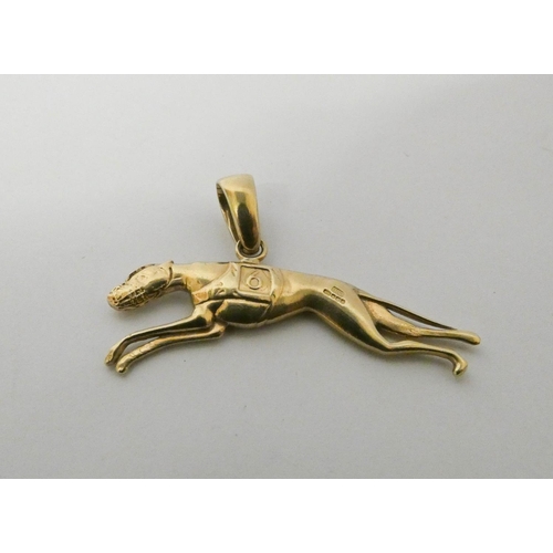 416 - A racing greyhound charm pendant, 5cms across, hallmarked 9ct gold, weight 10.8g