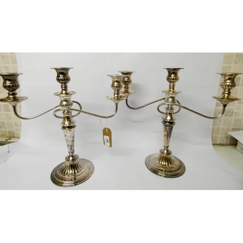 490 - A pair of silver plated three branch candelabra with detachable sconces