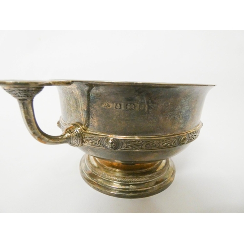 493 - A silver twin handled sugar bowl, decorated with simple Celtic deign bands and bosses, Birmingham 19... 