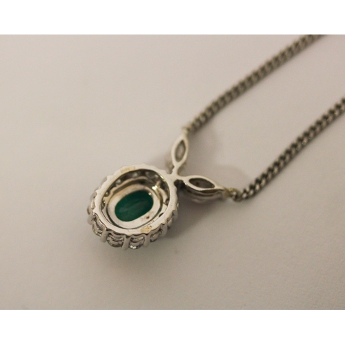 521 - A platinum emerald and diamond necklace, the cluster pendant, of oval shape  to platinum chain. Hall... 