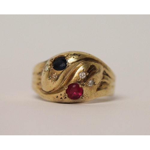 525 - A double headed serpent ring, the snakes heads set with sapphire and ruby, both with diamond eyes, h... 