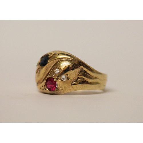 525 - A double headed serpent ring, the snakes heads set with sapphire and ruby, both with diamond eyes, h... 