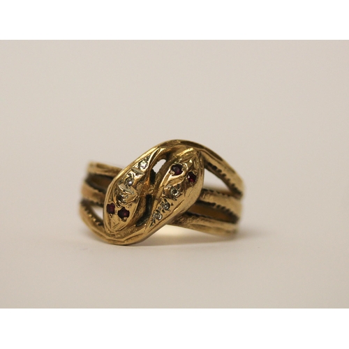 526 - A double headed serpent ring, the snakes heads set with rubies and diamonds, hallmarked 9ct yellow g... 