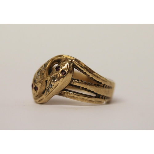 526 - A double headed serpent ring, the snakes heads set with rubies and diamonds, hallmarked 9ct yellow g... 