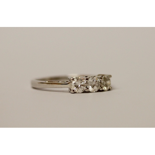 560 - A modern three stone diamond ring, each brilliant cut diamond weighing 0.25 carats approx, on hallma... 