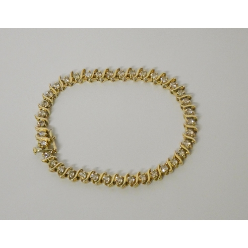 566 - A modern 14kt yellow gold tennis bracelet, set with brilliant cut diamonds, estimated total diamond ... 