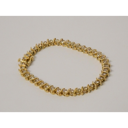 566 - A modern 14kt yellow gold tennis bracelet, set with brilliant cut diamonds, estimated total diamond ... 