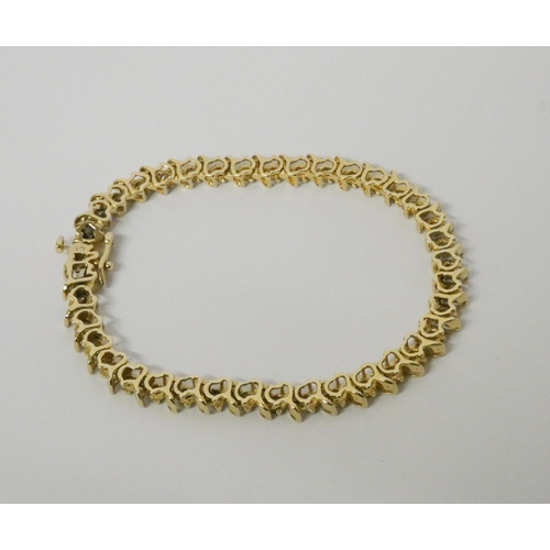 566 - A modern 14kt yellow gold tennis bracelet, set with brilliant cut diamonds, estimated total diamond ... 