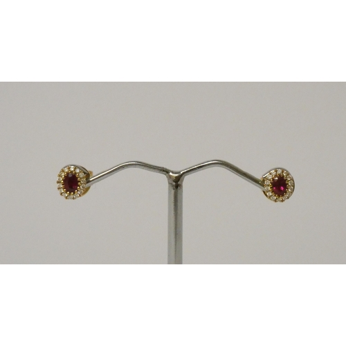 569 - A pair of ruby and diamond cluster ear studs, in 18ct yellow gold, posts hallmarked, 2.2 g