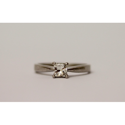 571 - A modern platinum solitaire diamond ring, with a claw set princess cut diamond on hallmarked platinu... 