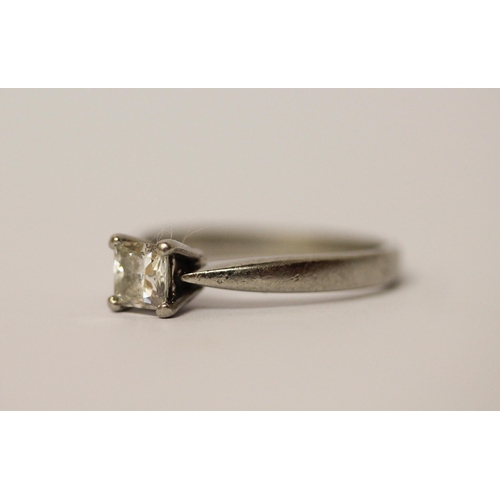 571 - A modern platinum solitaire diamond ring, with a claw set princess cut diamond on hallmarked platinu... 