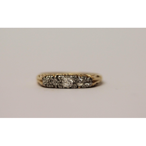 572 - An antique five stone diamond ring in a carved setting, band marked 18ct, ring size P, 3.5g