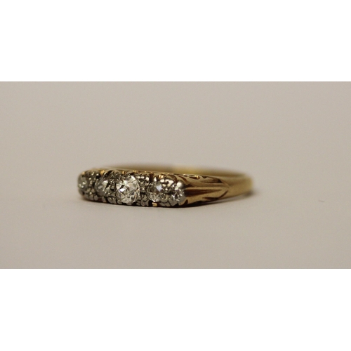 572 - An antique five stone diamond ring in a carved setting, band marked 18ct, ring size P, 3.5g