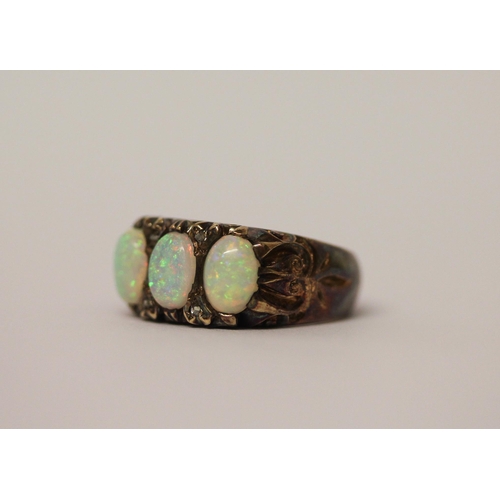 573 - An opal three stone and diamond ring, three large opals with good play of colour in 9ct gold setting... 