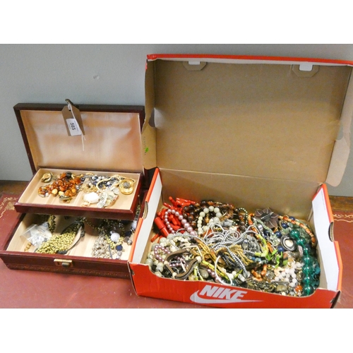 585 - A large quantity of assorted costume jewellery, some contained within a canter levered jewellery box