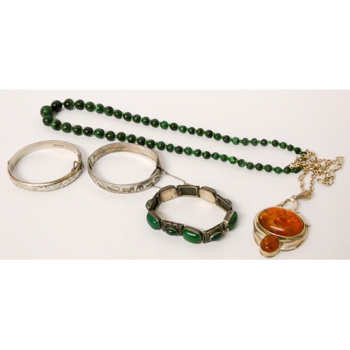 425 - A silver and amber chunky pendant on chain, silver bangle, malachite beads, green stone set bracelet... 