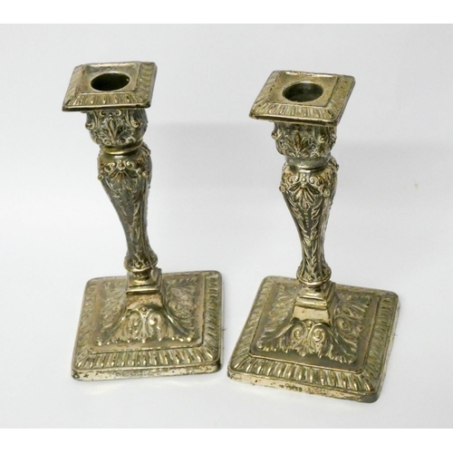 500 - A pair of square based silver candlesticks, with embossed decoration, fixed sconces,  Sheffield 1901... 