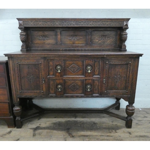 8 - A 1930's carved oak sideboard with low back, drawers and cupboards under, standing on bulbous legs, ... 