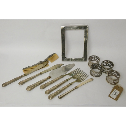 415 - A silver photograph frame, Elkington plated napkin rings, silver handled cutlery etc