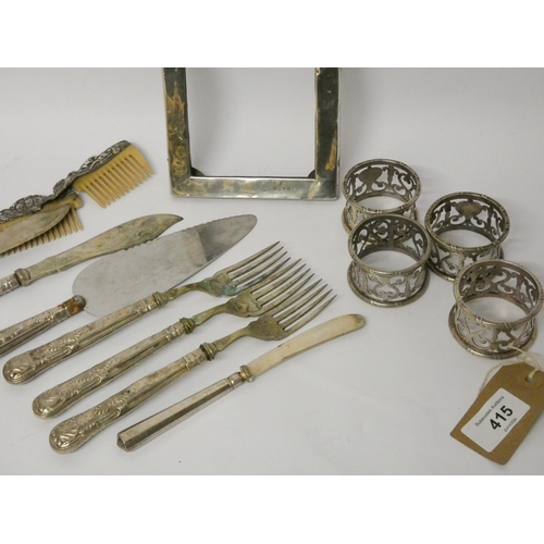 415 - A silver photograph frame, Elkington plated napkin rings, silver handled cutlery etc