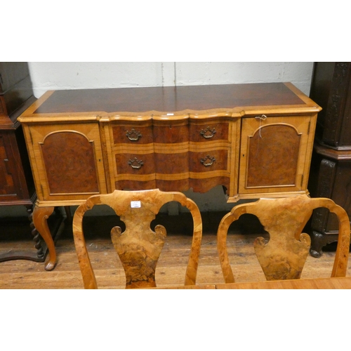 305 - A 1930's Queen Anne style walnut dining room suite with cross banded tops comprising extending table... 