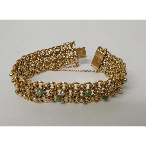 447 - A wide 9ct gold flexible link panel bracelet set with turquoise cabochons and seed pearls, clasp hal... 